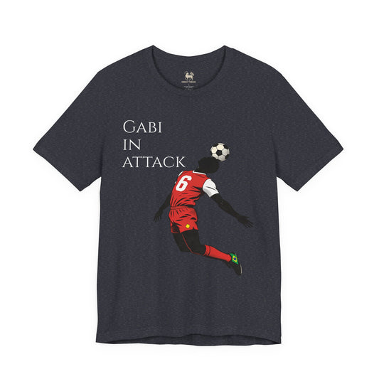 Detail view of the GABI IN ATTACK chest print on the Arsenal terrace chant tee by Unruly Thread — cartoon footballer in red and white kit, number 6.