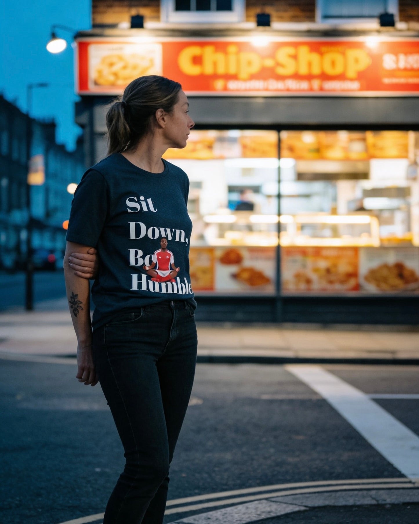 Natural cream Sit Down, Be Humble Arsenal tee by Unruly Thread — Lewis-Skelly meditation celebration design.