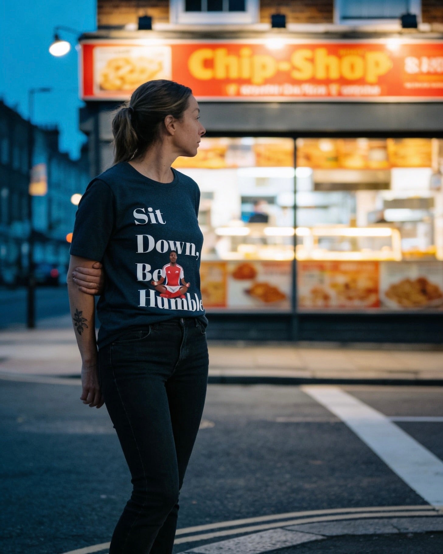Natural cream Sit Down, Be Humble Arsenal tee by Unruly Thread — Lewis-Skelly meditation celebration design.